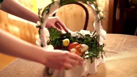Hand arranging easter basket brought to church to be blessed on Holy Saturday Stock Footage 103848855