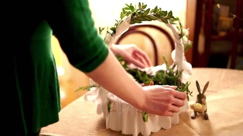 Hand arranging easter basket brought to church to be blessed on Holy Saturday Stock Footage 103849196