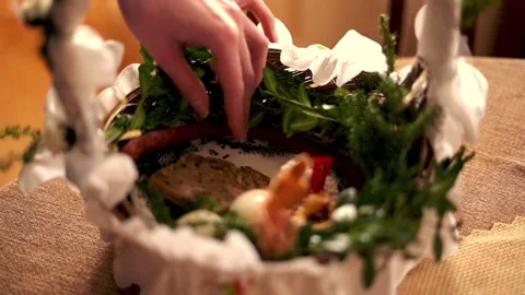 Hand arranging easter basket brought to church to be blessed on Holy Saturday Stock Footage 103849815