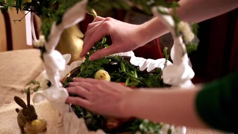 Hand arranging easter basket  brought to church to be blessed on Holy Saturday Stock Footage 104030392