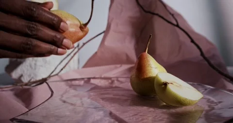 Hand Arranging Fresh Pears and Pear Slices on Table for Rustic Food Display Stock Footage 340324255