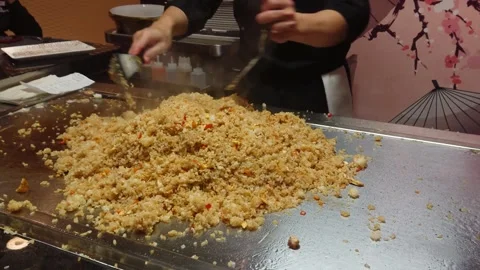 Hand of Asian Chef action cooking fried rice Teppanyaki style. Japanese Food. Video stock 305880799
