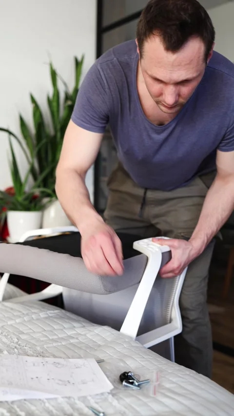 Hand assemble office chair do it yourself at home. DIY furniture assembly Stock Footage 332555359