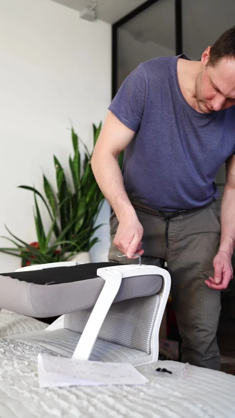 Hand assemble office chair do it yourself at home. DIY furniture assembly Stock Footage 332555403