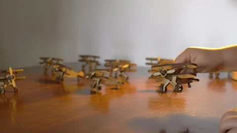 Hand Assembling Wooden Toy Airplanes on Table Stock Footage 342135841