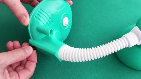 Hand Attaches Small Black Component to Green Device Lamps Stock-Footage 328698764