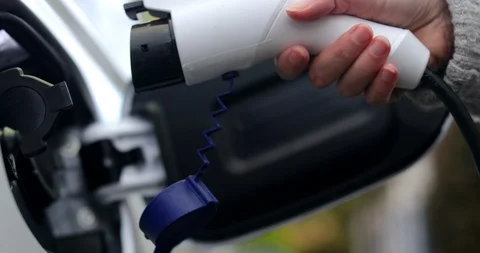 Hand Attaching Power Cable To Zero Emission Electric Car Stock Footage 119818717