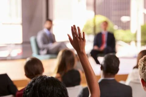 Hand in audience raised for a question at a business seminar Stock Photos