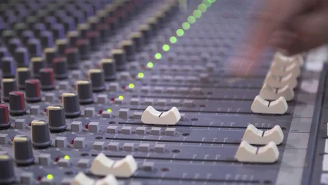 Hand of audio engineer sliding fader audio mixer Stock Footage 83317688