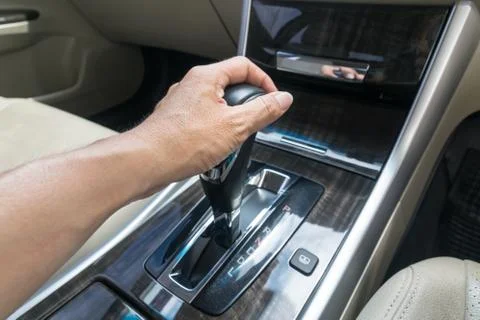 Hand on automatic gear shift, Man hand shifting an automatic car Stock Photos