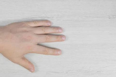 Hand on a background of bleached wood. Stock Photos