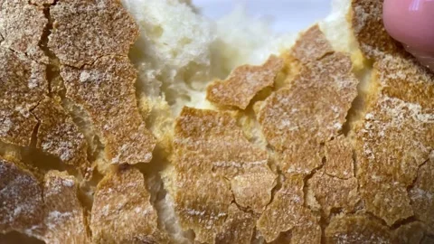 Hand baker breaks homemade bread. close up view Stock Footage 235831882