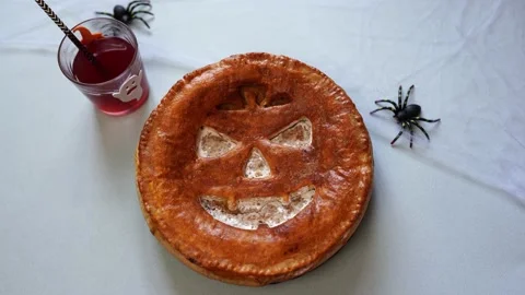 Hand of baker putting decorations on table near halloween pumpkin pie Stock Footage 140280435