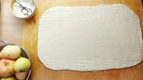 Hand of baker sprinkle cinnamon on the dough for pie. Stock Footage 97005573
