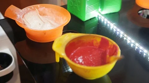 Hand of the Barber dips a brush into a bowl of hair dye Stock Footage 101190345
