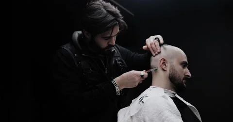 Hand of barber keeping straight razor and cutting trendy stripes on head Stock Footage 150273663