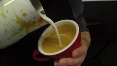 Hand of barista making latte or cappuccino coffee pouring milk making latte art Stock Footage 155506083