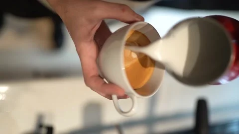 Hand Of Barista Making Latte Or Cappuccino Coffee Pouring Milk Making Latte Art Stock Footage 196151213
