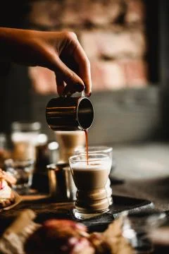 Hand of barista making making coffee in cafe. Cup of traditional espresso with Stock Photos