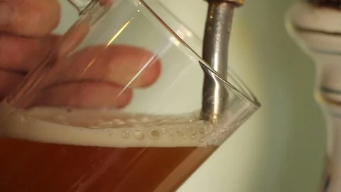 Hand of bartender pouring a large lager beer in tap Stock Footage 107435472