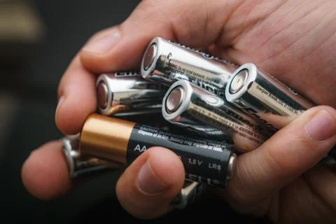 Hand with batteries Stock Photos