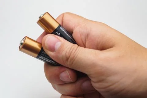 Hand with batteries Stock Photos
