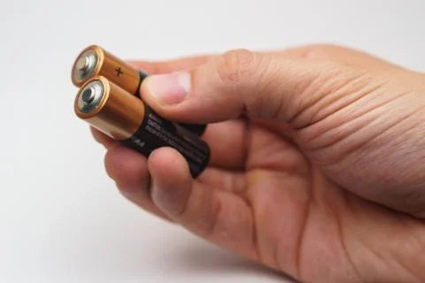 Hand with batteries Foto stock