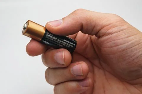 Hand with battery Stock Photos