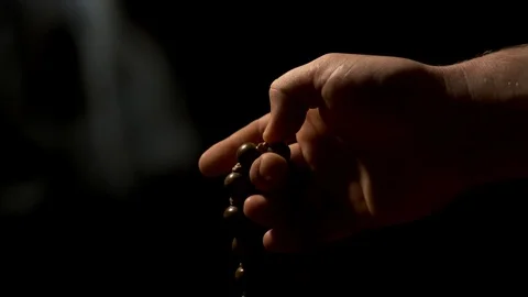 Hand with beads against black background - Eastern rosary with incense smoke Stock-Footage 119853937