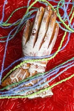 Hand in Beads Stock Photos