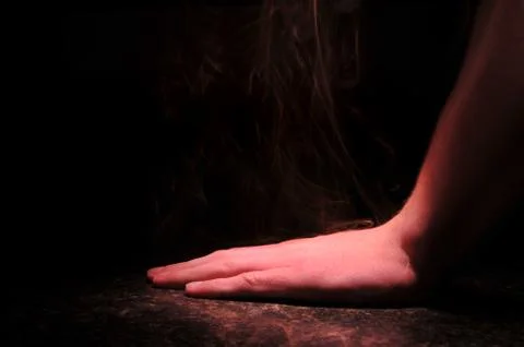 A hand being pressed an extremely hot surface burns with smoke Stock Photos