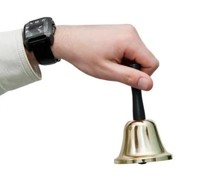 Hand with a bell Stock Photos