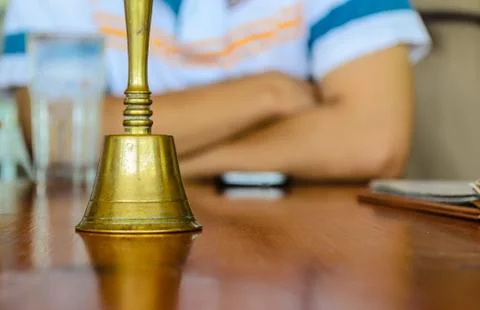 Hand bell on table Photos