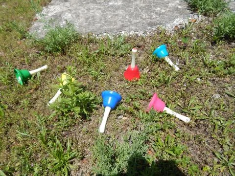 Hand Bells In The Grass Stock Photos