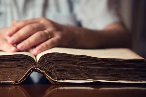 Hand on bible Stock Photos