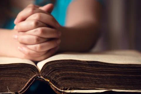 Hand on bible Stock Photos
