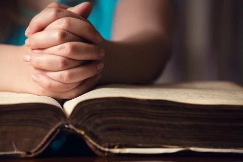 Hand on bible Stock Photos