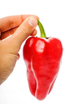 Hand with big red pepper Stock Photos
