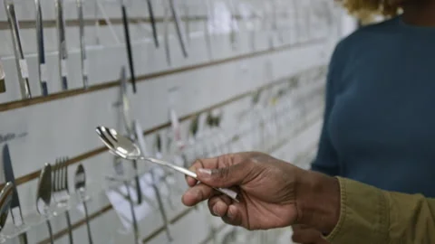 Hand of Black Man Inspecting Spoon at Kitchenware Store while Shopping Stock Footage 321772689