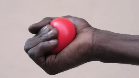 Hand of black man using rubber ball to do anti stress exercises Stock Footage 240391872