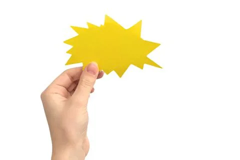 Hand with blank speech bubble in shape of boom or lightning, yellow color, is Stock Photos