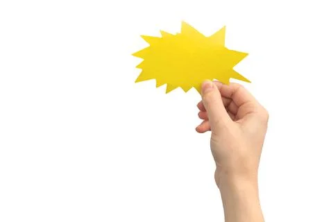 Hand with blank speech bubble in shape of boom or lightning, yellow color, is Stock Photos