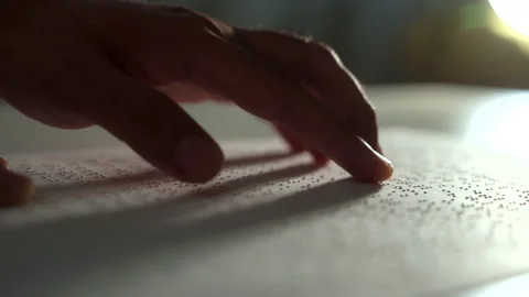 Hand of a blind person reading some braille text on page paper to learn. Finger  Stock-Footage 273136400