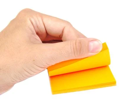 Hand with a block of yellow post it notes or notepapers on a white background Stock Photos