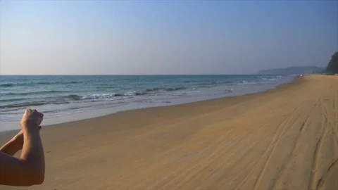 A hand blows soap bubbles on the beach Stock Footage 93920687