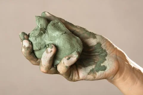 Hand with blue clay Stock Photos