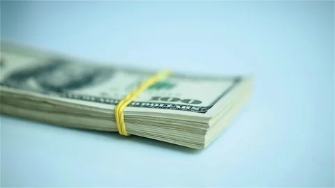 Hand in blue glove leafs through stack of US dollars. Closeup Stock Footage 72114801