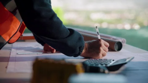 Hand, blueprint and architect at construction site for engineering, planning and Stock Footage 336201685
