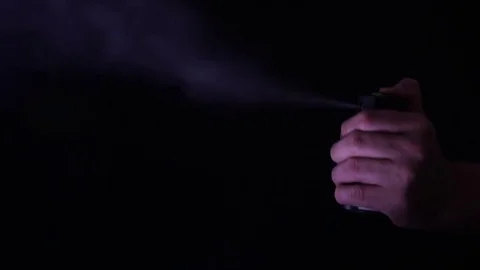 Hand with bottle of pepper spray, tear gas Video stock 77808533