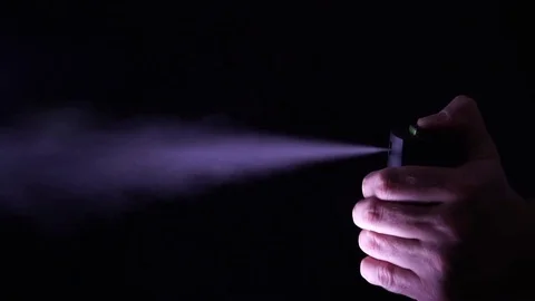 Hand with bottle of pepper spray, tear gas Stock Footage 77808555